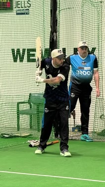 Indoor cricket batter playing a shot